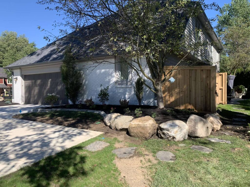 Boulder retaining wall Mulch Plants